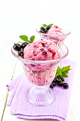 Image showing Ice cream with black currant in two glasses on light board