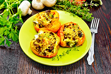 Image showing Pepper stuffed with mushrooms and couscous in green plate