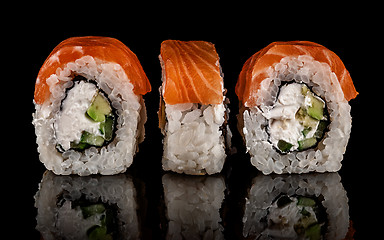 Image showing Three pieces of sushi rolls Philadelphia