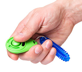 Image showing Hand with dog clicker on white