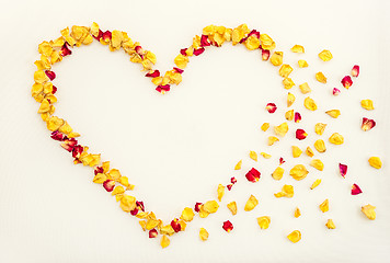 Image showing Floral heart with rose petals flying away