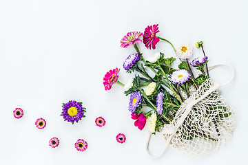 Image showing Bouquet of asters and dahlias in a mesh bag