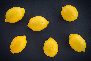 Image showing Fresh lemons on dark background