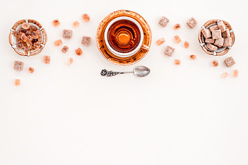 Image showing Cup of tea and pieces of brown sugar