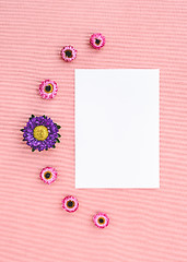 Image showing Flowers and white sheet of paper on pink canvas