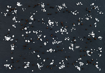 Image showing Flake sea salt and black pepper on dark background