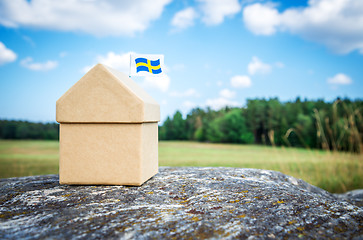 Image showing Little cardboard house with a Swedish flag