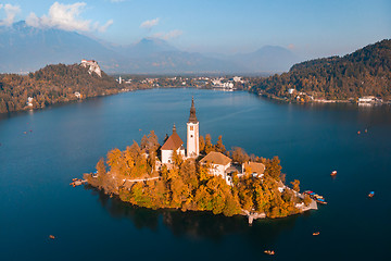 Image showing Aerial view of Bled island on lake Bled, and Bled castle and mountains in background, Slovenia.