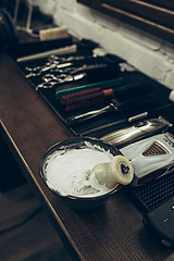 Image showing Barber shop tools on the table. Close up view shaving foam.