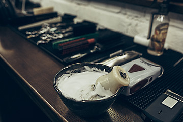 Image showing Barber shop tools on the table. Close up view shaving foam.