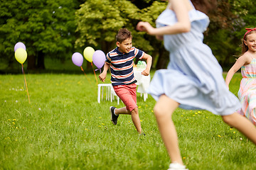 Image showing happy kids playing tag game at birthday party