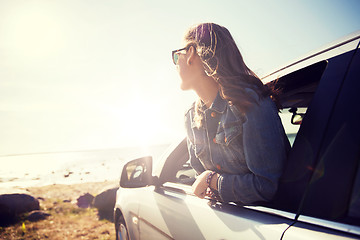 Image showing happy teenage girl or young woman in car