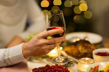 Image showing close up of man drinking red wine on christmas