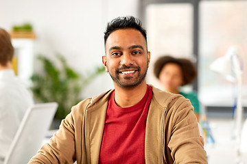 Image showing smiling indian man at office