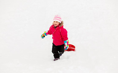 Image showing little girl with sled on snow hill in winter