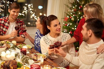 Image showing friends celebrating christmas and drinking wine