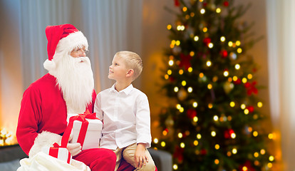 Image showing boy and santa with christmas gifts at home