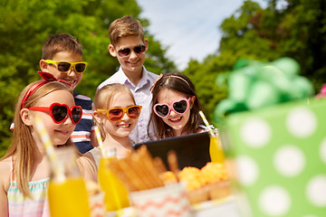 Image showing happy kids with tablet pc on birthday party