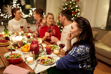 Image showing woman calling on smartphone at christmas dinner