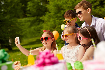 Image showing happy kids taking selfie on birthday party