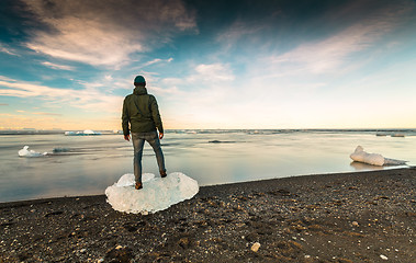 Image showing Man standing over a block of Ice