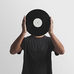 Image showing DJ holding a vinyl disk