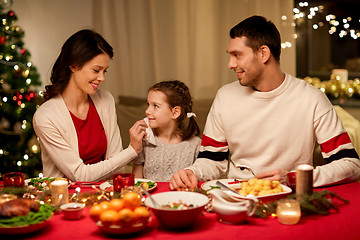 Image showing happy family having christmas dinner at home