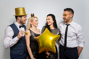 Image showing happy friends with golden party props posing