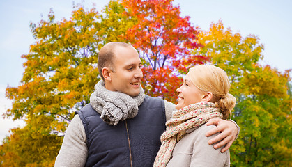 Image showing smiling couple leaves in autumn park