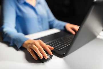 Image showing close up of female hand using computer mouse