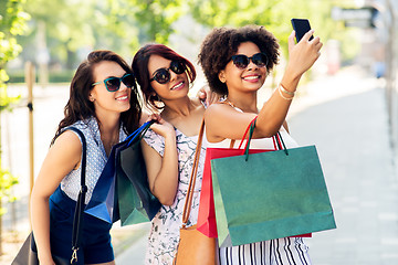 Image showing women with shopping bags taking selfie in city