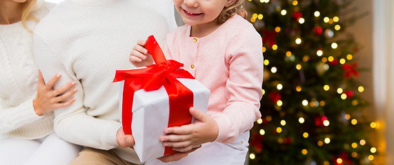 Image showing close up of happy family with christmas gift