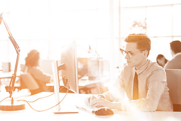 Image showing Young businessman using computer at work