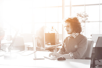 Image showing Young businessman using computer at work