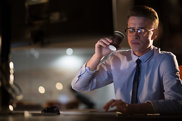 Image showing Tired businessman working late