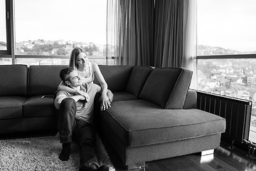 Image showing young handsome couple hugging on the sofa