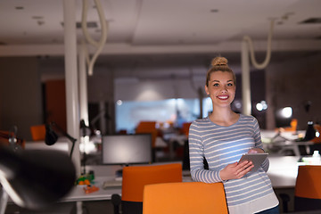 Image showing woman working on digital tablet in night office