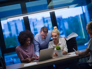 Image showing Multiethnic startup business team in night office