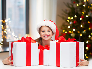 Image showing happy girl with christmas gifts at home