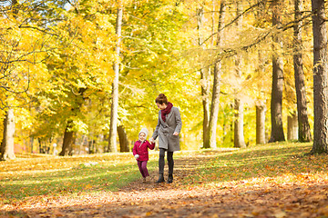 Image showing happy mother and little daughter at autumn park