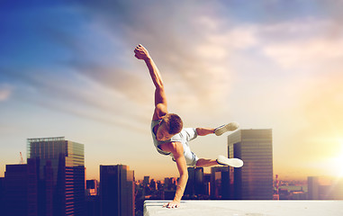 Image showing man making parkour jumping over tokyo city