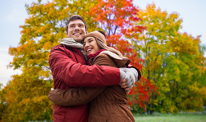 Image showing happy teenage couple hugging in autumn park