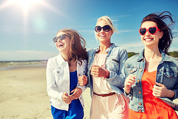 Image showing group of smiling women in sunglasses on beach