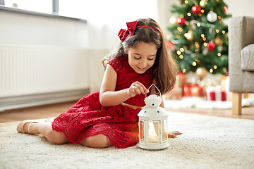 Image showing little girl with lantern at home on christmas