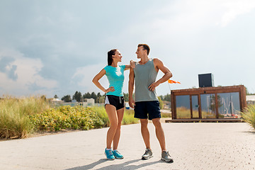 Image showing happy couple in sports clothes outdoors