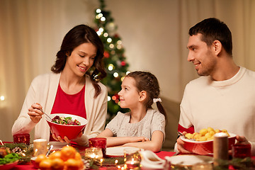 Image showing happy family having christmas dinner at home