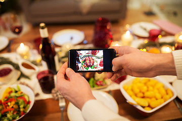 Image showing hands photographing food at christmas dinner