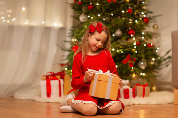 Image showing smiling girl with christmas gift at home