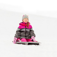 Image showing happy little girl on sled outdoors in winter