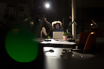 Image showing businessman sitting with legs on desk at office